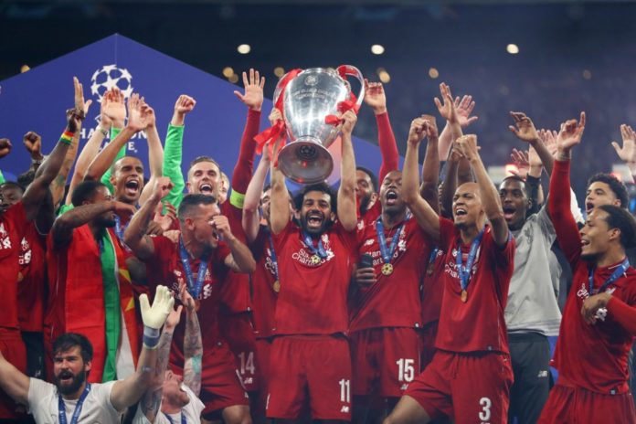 Mohamed Salah of Liverpool celebrates with Champions League Trophy in 2019