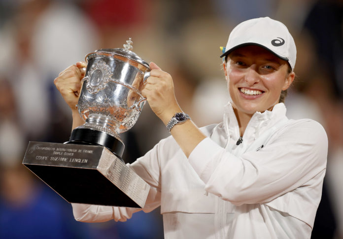 Iga Swiatek celebrates with the trophy at the French Open in June 2022