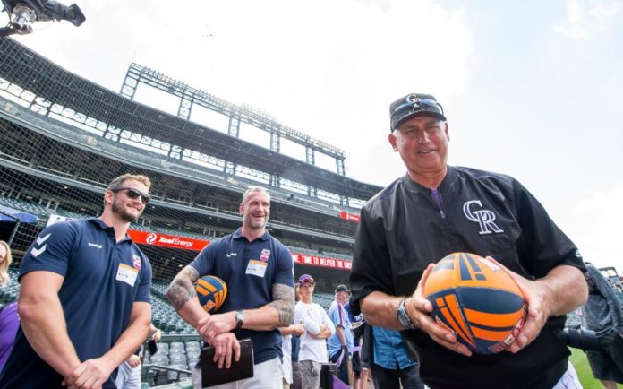 Colorado Rockies coach Bud Black with a rugby ball