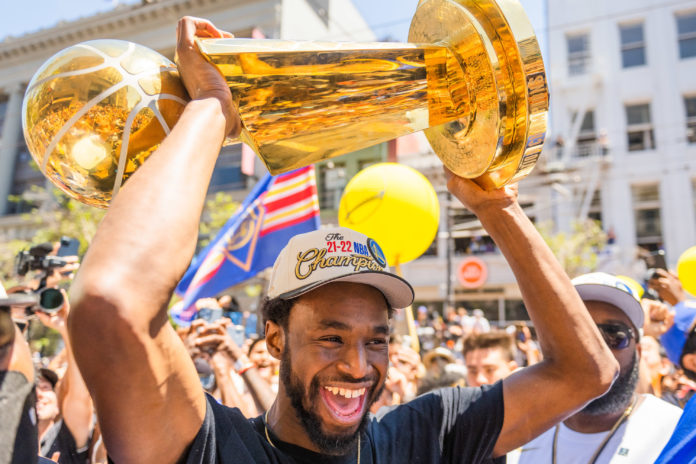 Andrew Wiggins holds the Larry O'Brien Trophy during the Golden State Warriors Championship Parade