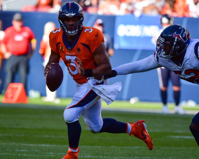Denver Broncos quarterback Russell Wilson (3) escapes the rush