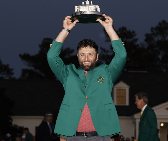 Jon Rahm wearing the green jacket holds the Masters trophy after winning the 87th Masters tournament at Augusta National in April 2023