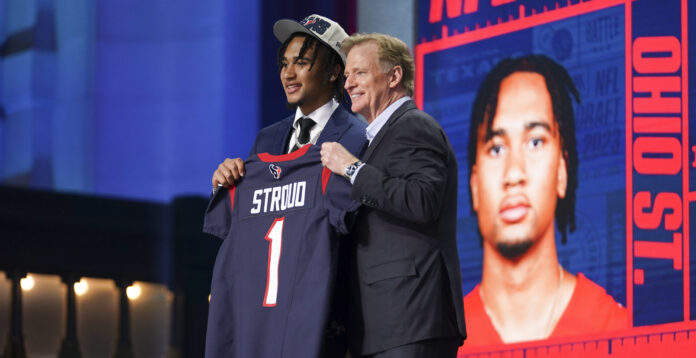 C.J. Stroud poses for a photo with NFL Commissioner Roger Goodell after being picked 3rd during the NFL Draft at Union Station in Kansas City, Missouri