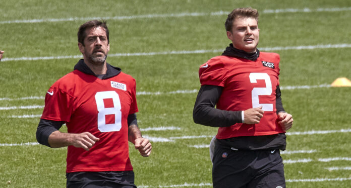 New York Jets quarterbacks Aaron Rodgers (8) and Zach Wilson (2) warm up before practice in June 2023