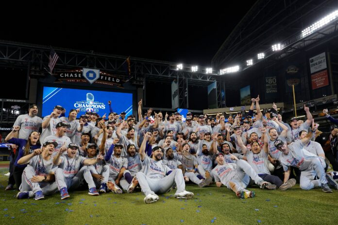 Texas Rangers players and staff pose for a group photo after defeating the Arizona Diamondbacks 5-0 to win the 2023 World Series in November 2023