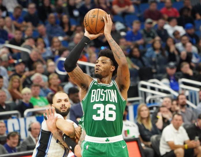 Boston Celtics player Marcus Smart #36 shoots a three point at the Amway Center in January 2020